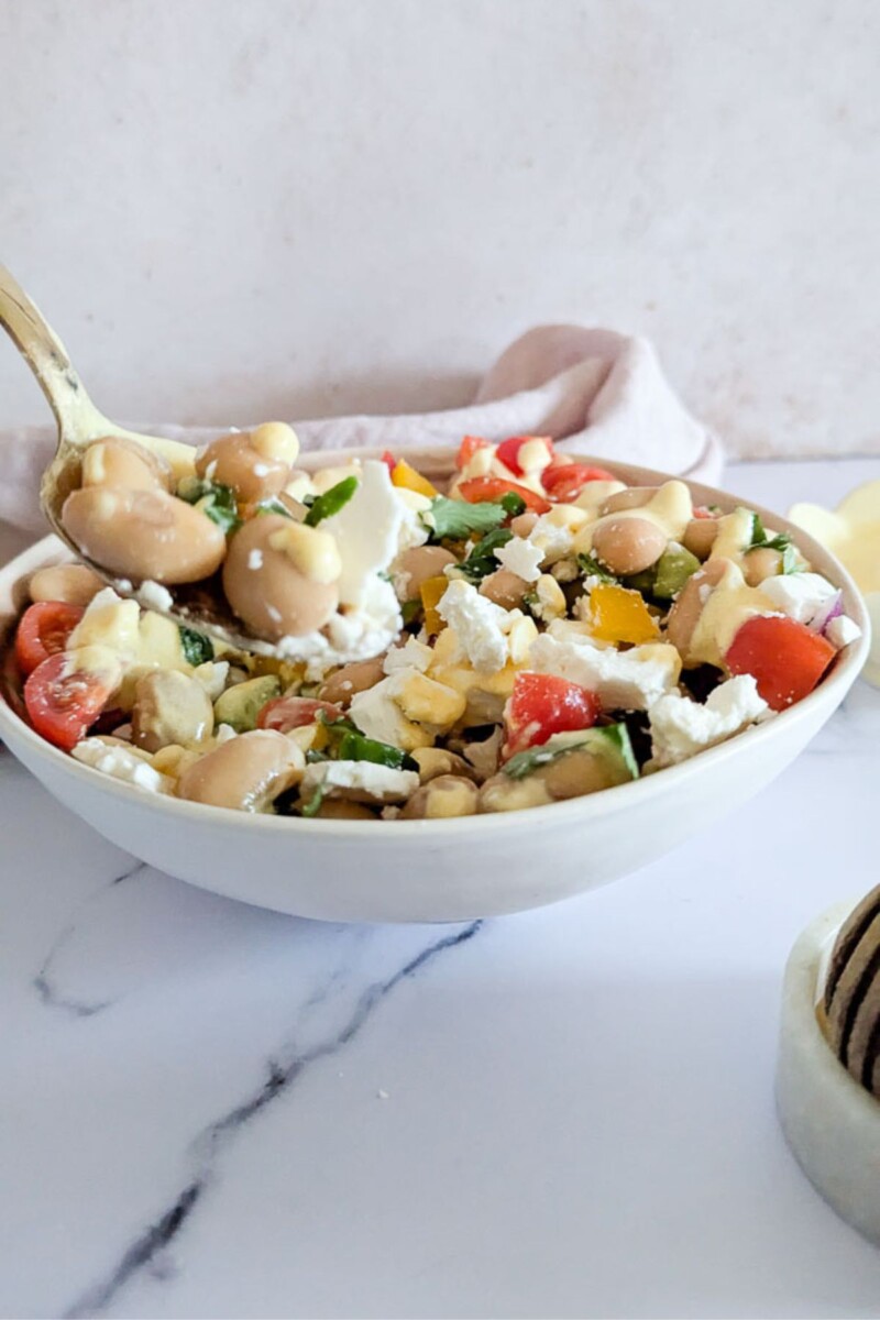 A picture of bean and feta salad taken from the side.