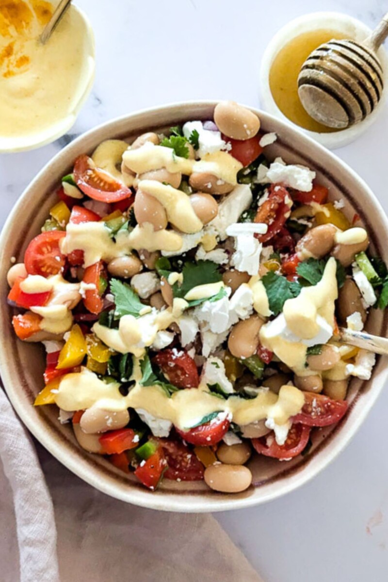 A close up shot of butter bean and feta salad in a bowl.