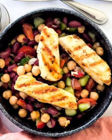 Halloumi chickpea salad inside a black bowl.