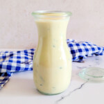 A glass of Tahini and Greek yogurt dressing with mint.