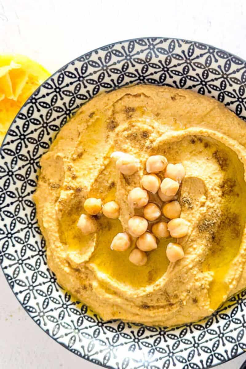 A close-up shot of hummus in a bowl.