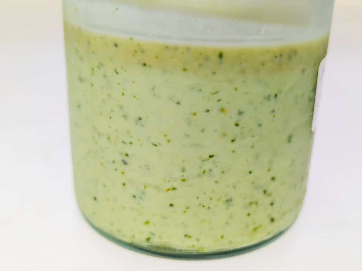 Jar of avocado showing a light brown layer at the top from oxidation.