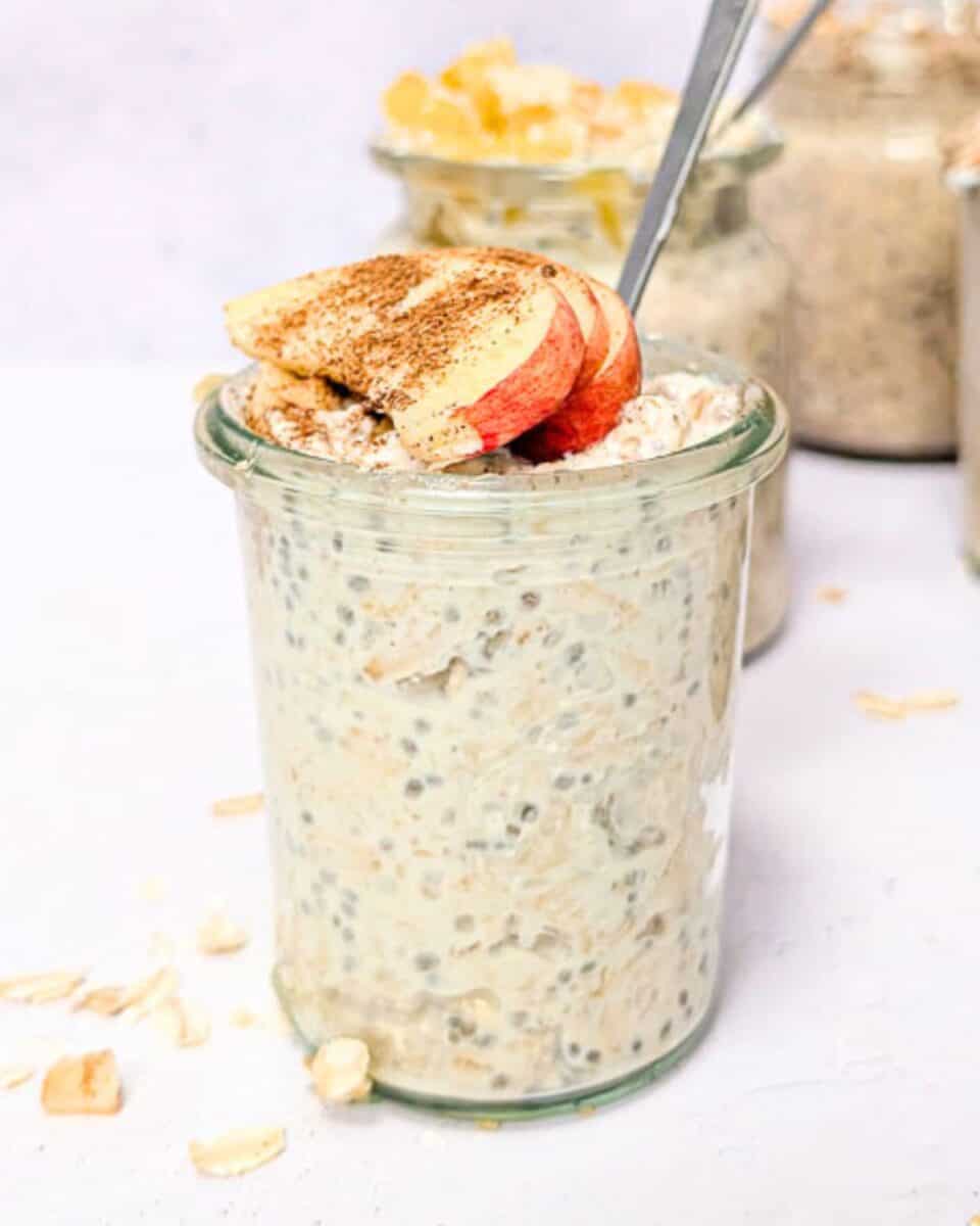 Delicious overnight oats with apples and cinnamon in a glass jar.
