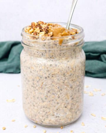 Quinoa overnight oats topped with chopped nuts and nut butter.