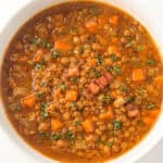 A bowl of lentil and bacon soup.