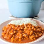 Vegetarian fasoulia with white beans in tomato sauce served with rice.