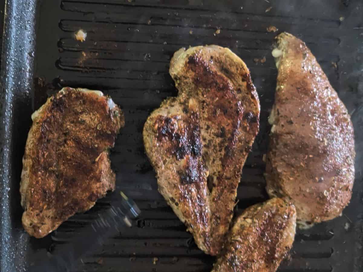 Cooking chicken in a pan.