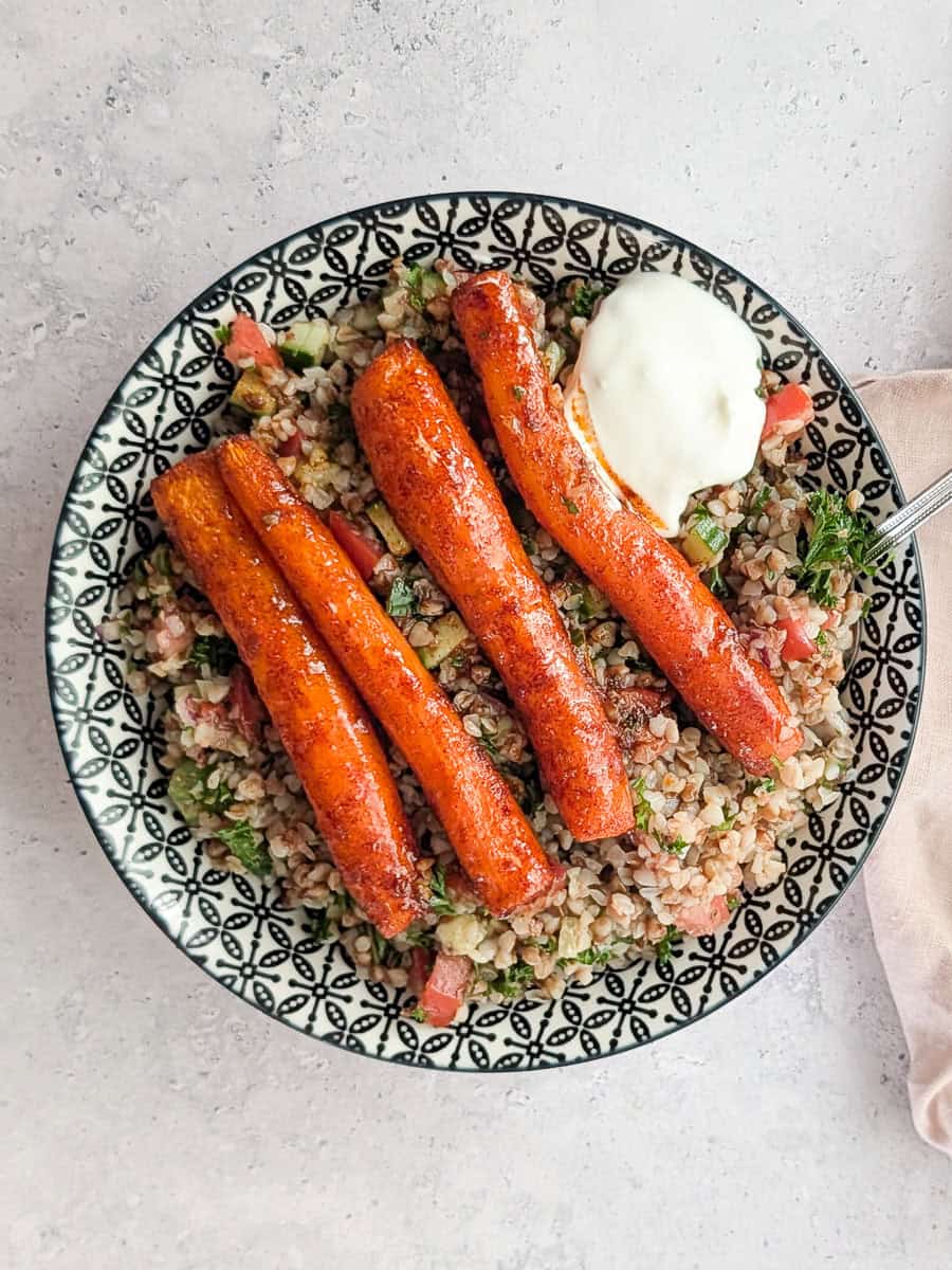 Roasted carrots served over buckwheat tabbouleh, and garnished with some yogurt.