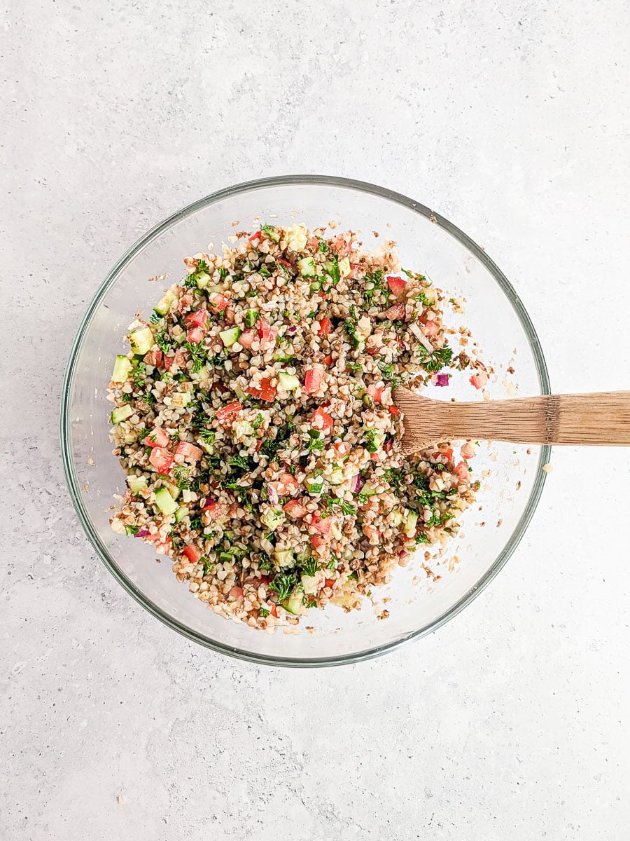 Healthy buckwheat tabbouleh in a glass bowl, ready to serve.